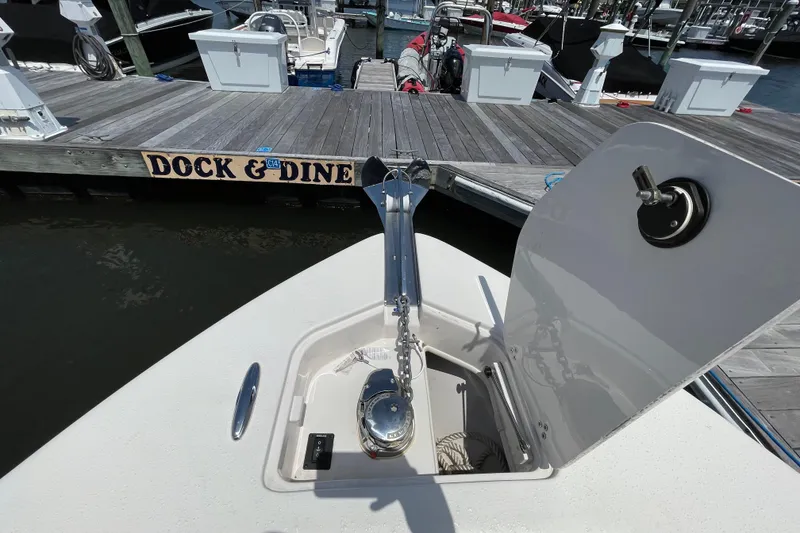 Slide: The Image of 2023 Sea Chaser 24 HFC boat at dock with anchor compartment open. - 9