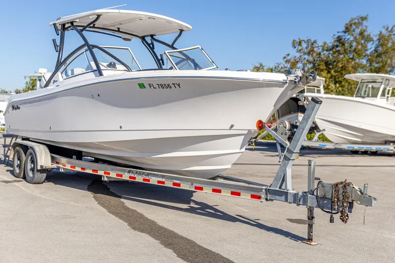 Slide: The Image of 2025 Edgewater 248CX Crossover boat on trailer, parked outdoors in sunny weather. - 11