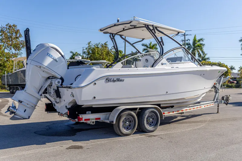 Slide: The Image of 2025 Edgewater 248CX Crossover boat on trailer, featuring Yamaha outboard motor. - 12