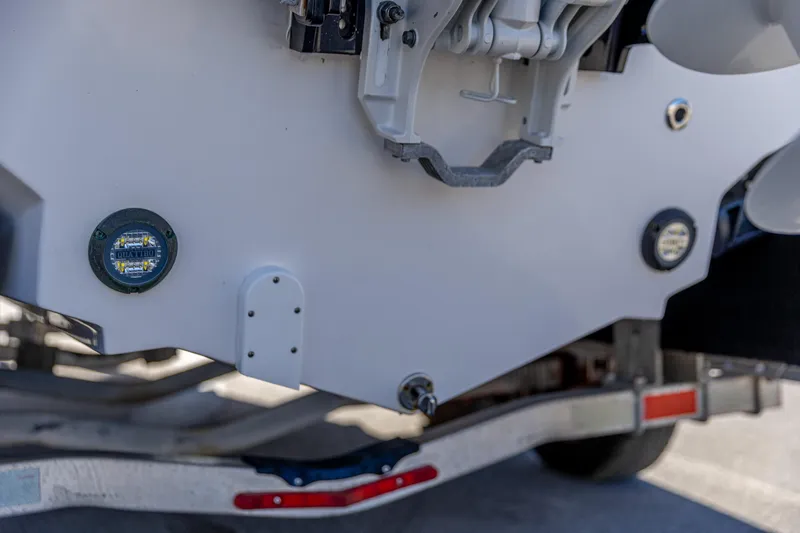 Slide: The Image of 2025 Edgewater 248CX Crossover boat on trailer, showing rear details and components. - 15