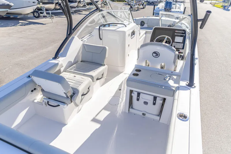 Slide: The Image of 2025 Edgewater 248CX Crossover boat interior with seating and helm, showcasing modern design. - 2