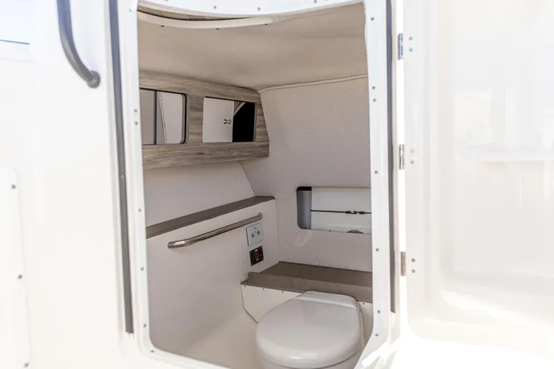 Slide: The Image of Interior of 2025 Edgewater 248CX Crossover boat, featuring a compact bathroom. - 4