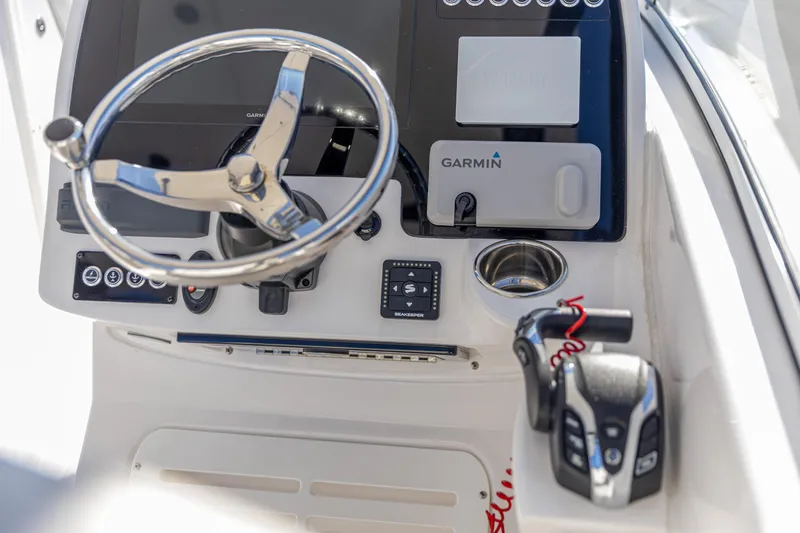 Slide: The Image of 2025 Edgewater 248CX Crossover boat dashboard with Garmin navigation and steering wheel. - 5