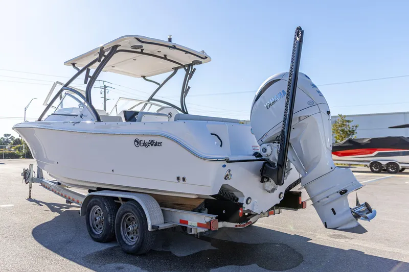 Slide: The Image of 2025 Edgewater 248CX Crossover boat on trailer, featuring Yamaha outboard motor. - 6