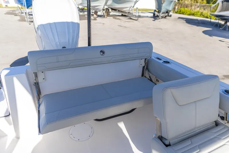 Slide: The Image of 2025 Edgewater 248CX Crossover boat interior with gray seating and cup holders. - 7