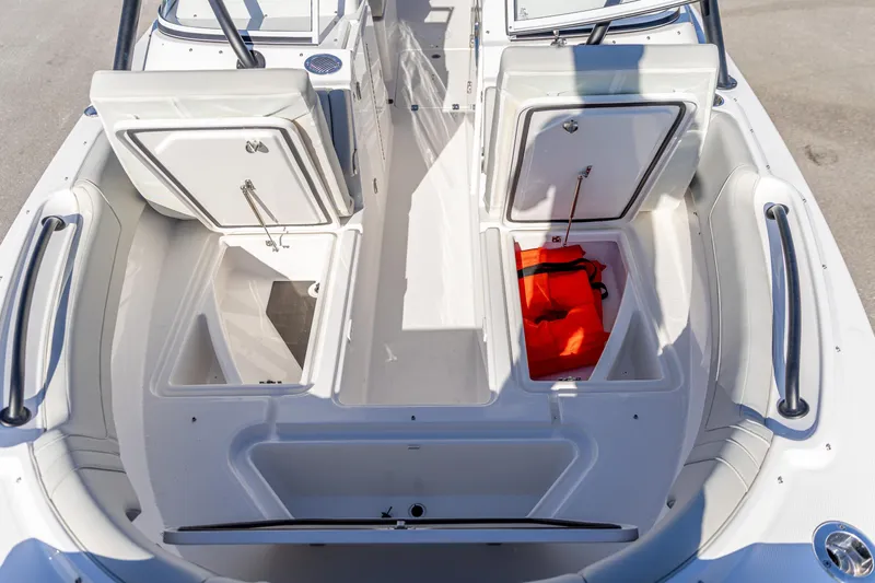 Slide: The Image of 2025 Edgewater 248CX Crossover boat interior with storage compartments and safety equipment. - 8