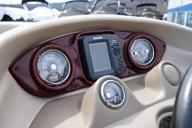 Slide: The Image of Dashboard of a 2012 South Bay 722CR boat with gauges and a central display. - 11