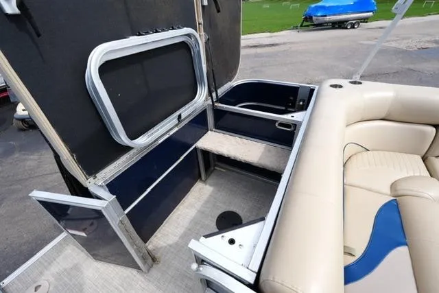 Slide: The Image of 2012 South Bay 722CR boat interior with seating and storage compartments. - 14