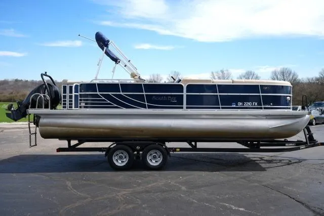 Slide: The Image of 2012 South Bay 722CR pontoon boat on trailer, parked outdoors under clear sky. - 4