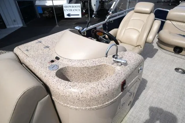 Slide: The Image of 2012 South Bay 722CR boat interior with beige seating and granite-look countertop. - 9