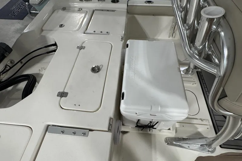 Slide: The Image of Interior view of a 2026 Key West 210 Bay Reef boat, featuring storage compartments and seating. - 10