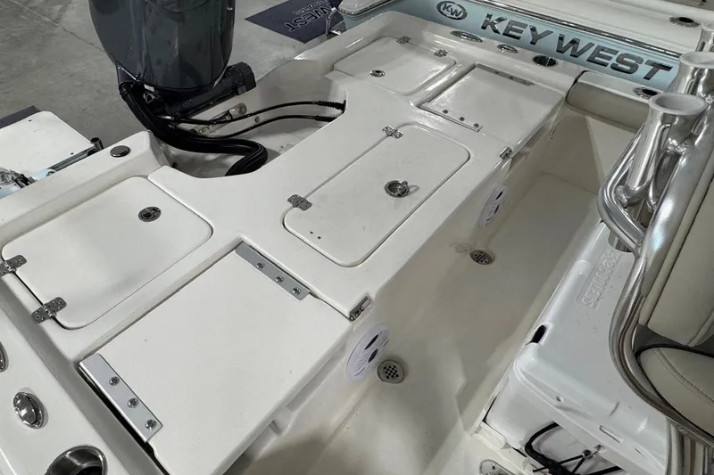 Slide: The Image of 2026 Key West 210 Bay Reef boat interior with storage compartments and seating. - 11