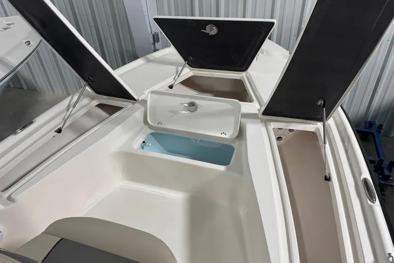 Slide: The Image of 2026 Key West 210 Bay Reef boat with open storage compartments and sleek design. - 13