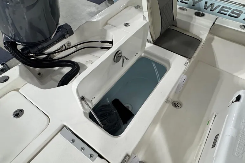 Slide: The Image of 2026 Key West 210 Bay Reef boat interior with open storage compartment and seating. - 17