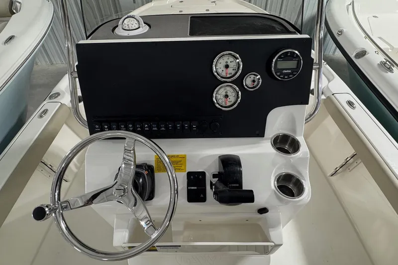 Slide: The Image of 2026 Key West 210 Bay Reef boat console with steering wheel and gauges. - 3