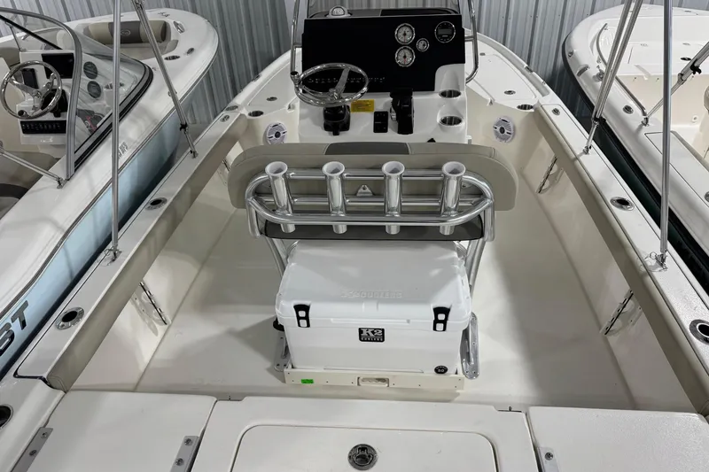 Slide: The Image of 2026 Key West 210 Bay Reef boat interior with steering console and rod holders. - 4