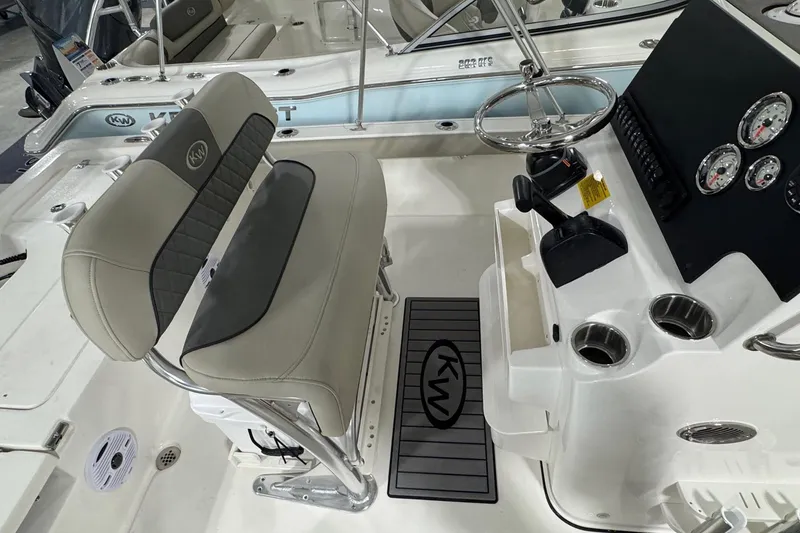 Slide: The Image of 2026 Key West 210 Bay Reef boat interior with steering wheel, gauges, and seating. - 7