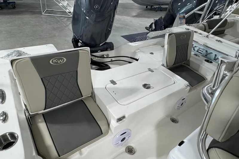 Slide: The Image of 2026 Key West 210 Bay Reef boat interior with cushioned seating and storage compartments. - 8