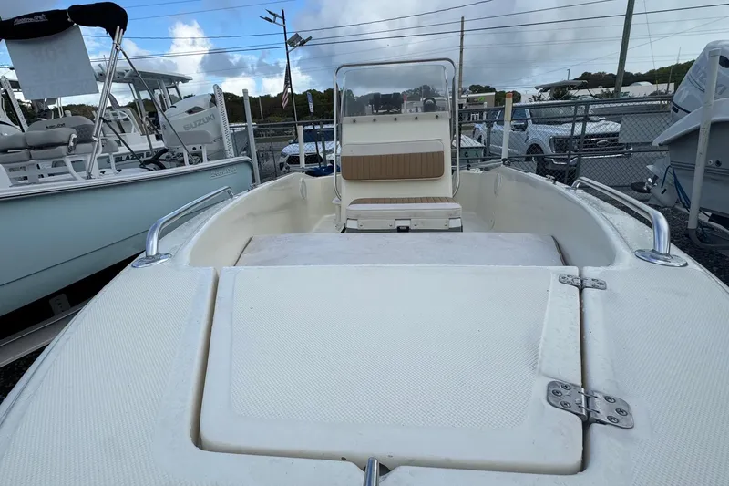 Slide: The Image of 2001 Scout 175 Sportfish boat with seating and storage, displayed outdoors. - 2
