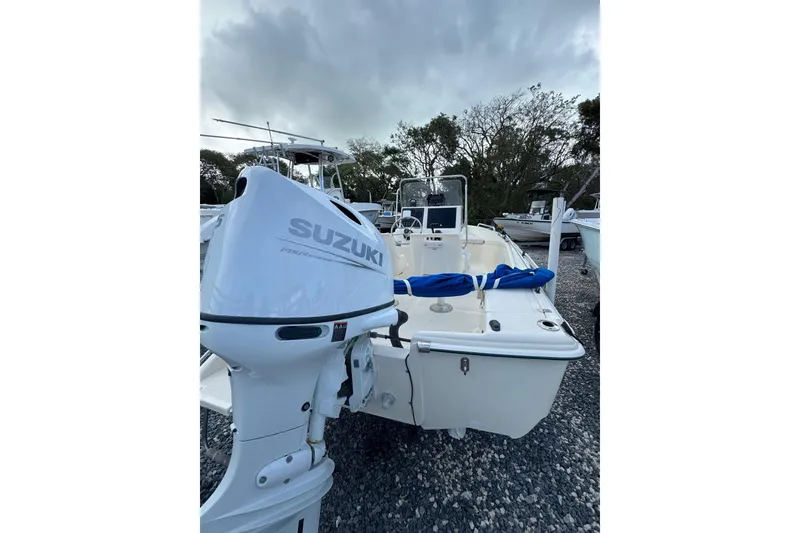 Slide: The Image of 2001 Scout 175 Sportfish boat with Suzuki outboard motor on gravel lot. - 4