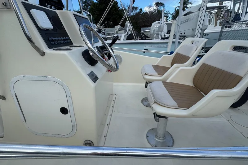 Slide: The Image of 2001 Scout 175 Sportfish boat interior with steering wheel and two cushioned seats. - 5
