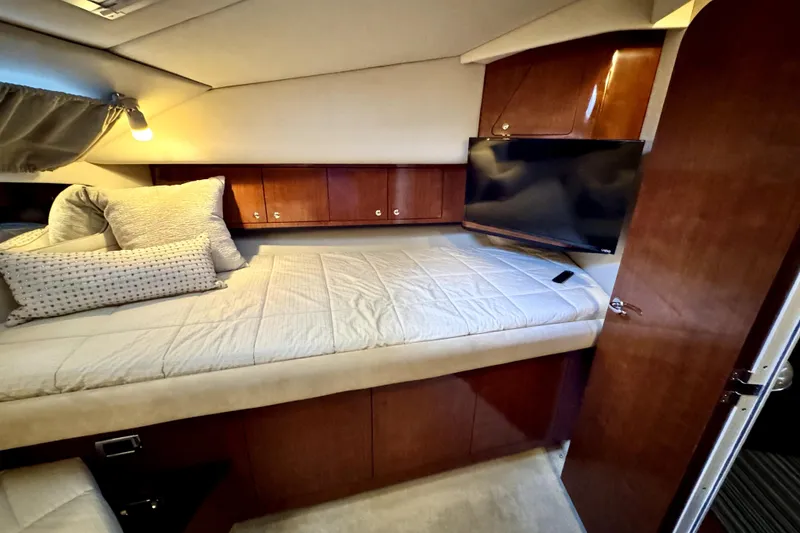 Slide: The Image of Luxurious cabin interior of 2003 Sea Ray 390 Motor Yacht with cozy bedding and TV. - 10