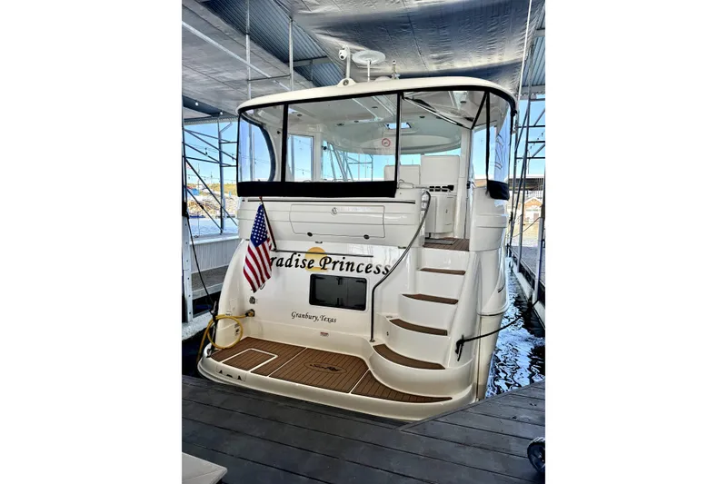 Slide: The Image of 2003 Sea Ray 390 Motor Yacht docked, displaying "Paradise Princess" and American flag. - 2