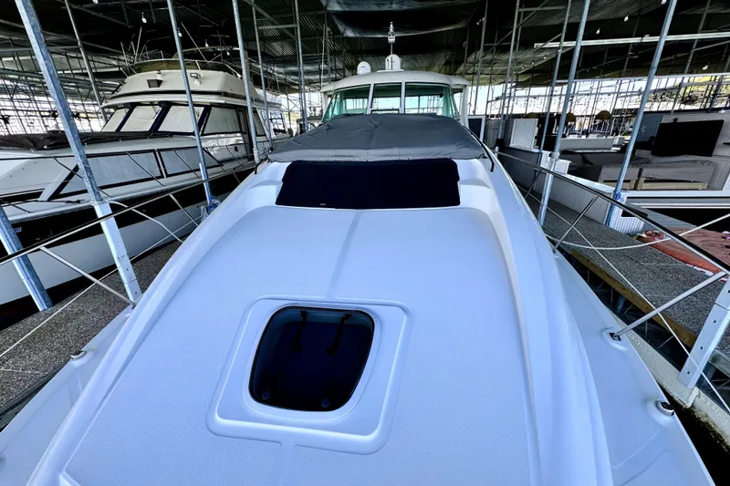 Slide: The Image of 2003 Sea Ray 390 Motor Yacht docked in a marina, showcasing sleek design and covered deck. - 3