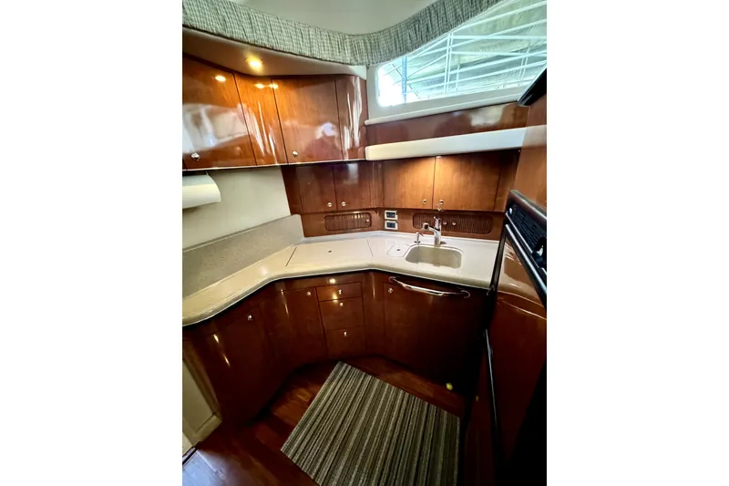 Slide: The Image of Interior of 2003 Sea Ray 390 Motor Yacht, elegant kitchen with wooden cabinets. - 6