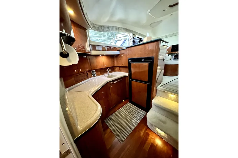 Slide: The Image of Interior of 2003 Sea Ray 390 Motor Yacht with modern kitchen and wooden cabinetry. - 7