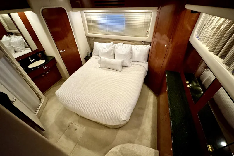 Slide: The Image of Luxurious bedroom interior of 2003 Sea Ray 390 Motor Yacht with elegant wood finishes. - 8