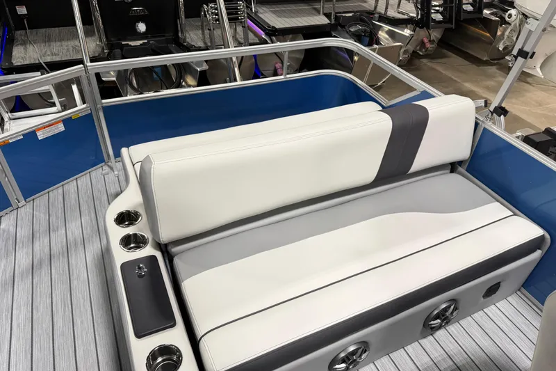 Slide: The Image of 2026 SunCatcher Select 322SL boat interior with cushioned seating and cup holders. - 6