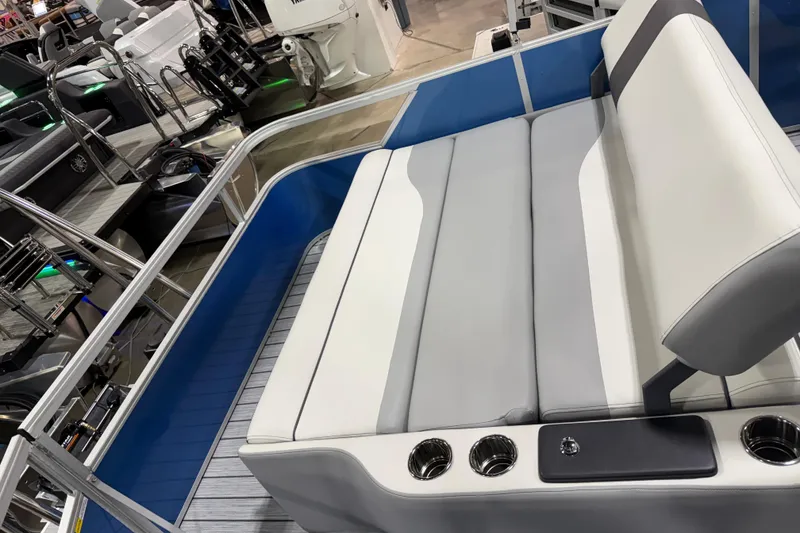 Slide: The Image of 2026 SunCatcher Select 322SL boat interior with sleek seating and cup holders. - 7