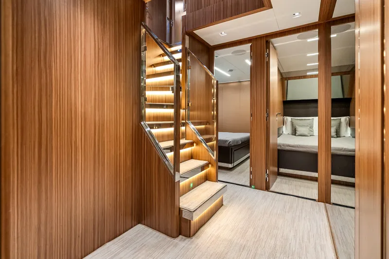 Slide: The Image of Luxurious interior of 2020 Riva 100' Corsaro yacht with elegant wooden staircase. - 13