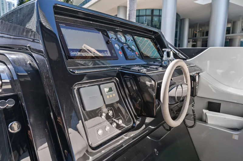 Slide: The Image of Control panel of a 2020 Riva 100' Corsaro yacht, featuring modern navigation equipment. - 16