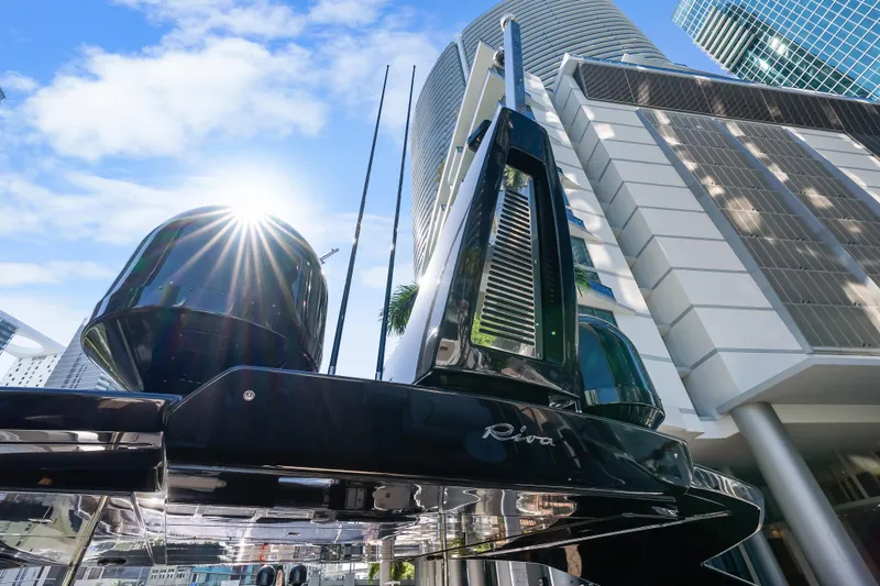 Slide: The Image of Riva 100' Corsaro yacht against modern skyscrapers, sunburst effect, 2020 model. - 26