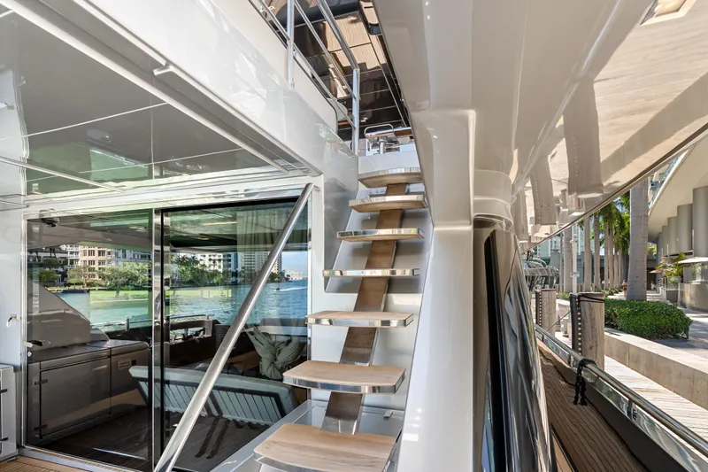 Slide: The Image of Luxurious Riva 100' Corsaro yacht interior with sleek staircase and waterfront view, 2020 model. - 27