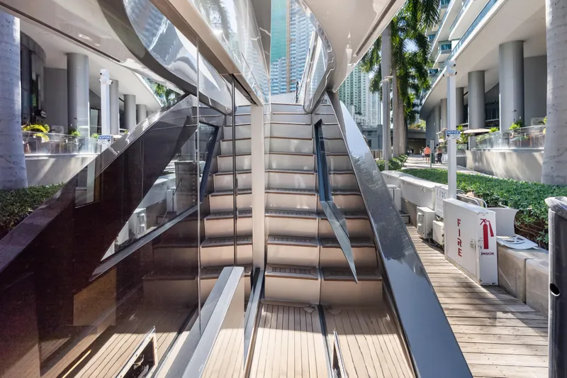 Slide: The Image of Staircase on a 2020 Riva 100' Corsaro yacht docked at a modern marina. - 38