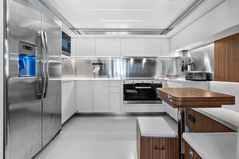 Slide: The Image of Modern kitchen interior on 2020 Riva 100' Corsaro yacht, featuring stainless steel appliances and sleek design. - 45