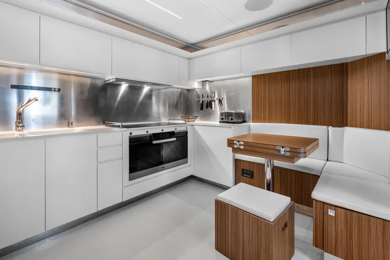 Slide: The Image of Modern kitchen interior on 2020 Riva 100' Corsaro yacht, featuring sleek cabinetry and stainless steel appliances. - 47