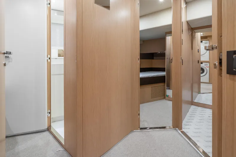 Slide: The Image of Interior of 2020 Riva 100' Corsaro yacht, featuring wooden doors and modern design. - 48