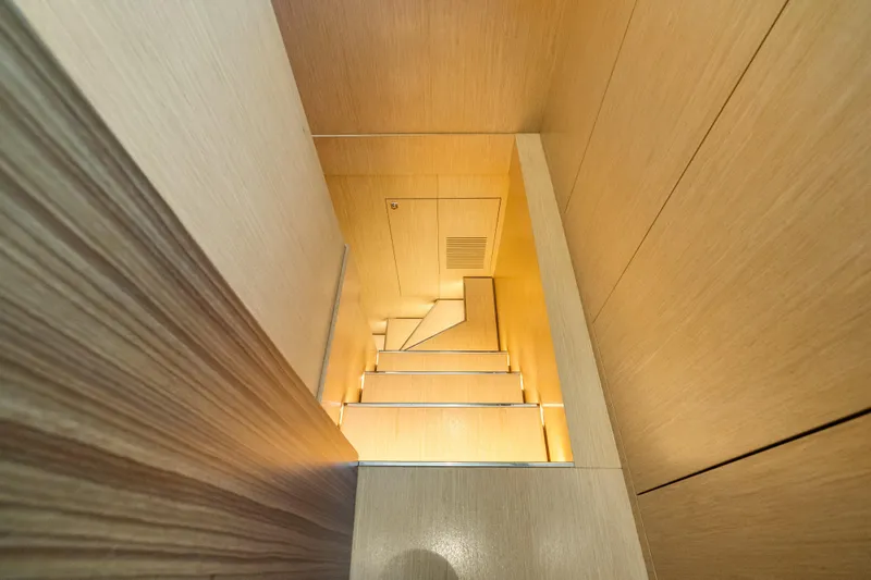 Slide: The Image of Staircase inside 2020 Riva 100' Corsaro yacht, featuring sleek wooden design. - 51
