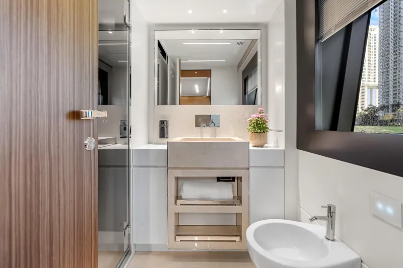 Slide: The Image of Luxurious bathroom interior on 2020 Riva 100' Corsaro yacht, featuring modern sink and window view. - 68