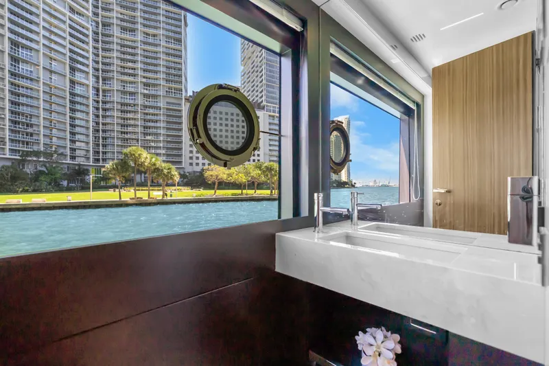 Slide: The Image of Luxurious bathroom view from 2020 Riva 100' Corsaro yacht, overlooking city skyline and water. - 75