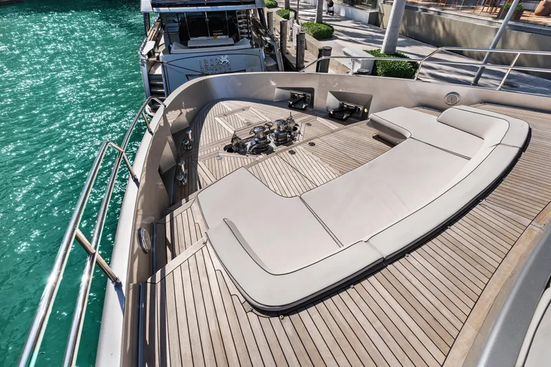 Slide: The Image of Luxurious 2020 Riva 100' Corsaro yacht deck with elegant seating and turquoise water. - 9