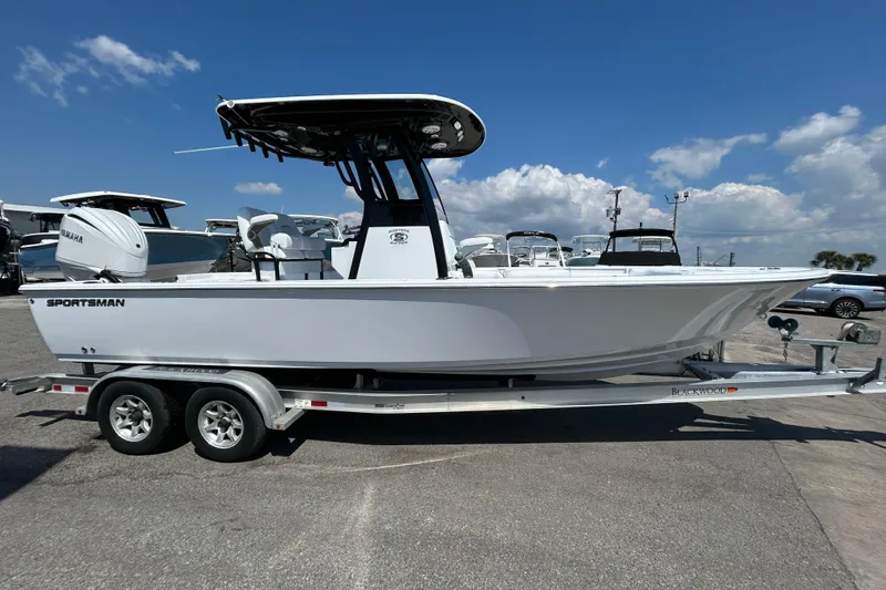 The Image of 2026 Sportsman Masters 247OE Bay Boat on trailer under clear blue sky. - 0