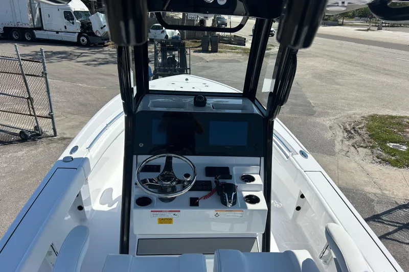 Slide: The Image of 2026 Sportsman Masters 247OE Bay Boat cockpit with steering wheel and control panel. - 12