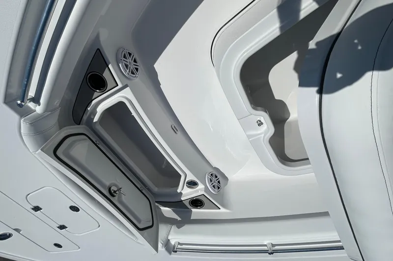 Slide: The Image of Interior compartments of a 2026 Sportsman Masters 247OE Bay Boat, showcasing storage and speaker features. - 15
