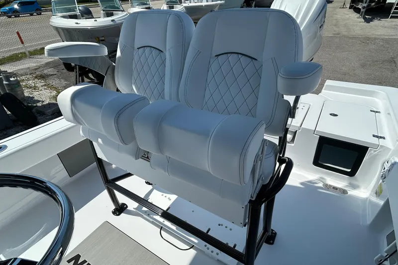 Slide: The Image of Luxurious seating on 2026 Sportsman Masters 247OE Bay Boat, featuring white cushioned chairs. - 18