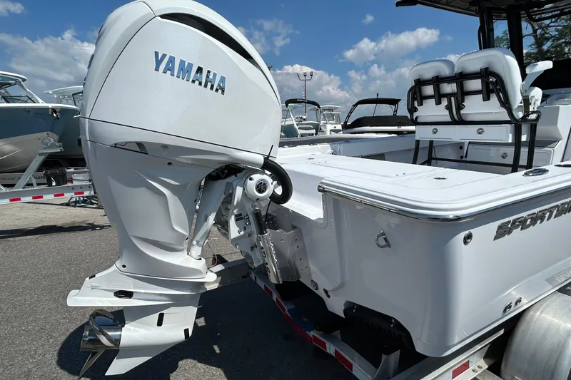 Slide: The Image of 2026 Sportsman Masters 247OE Bay Boat with Yamaha engine, displayed outdoors. - 7